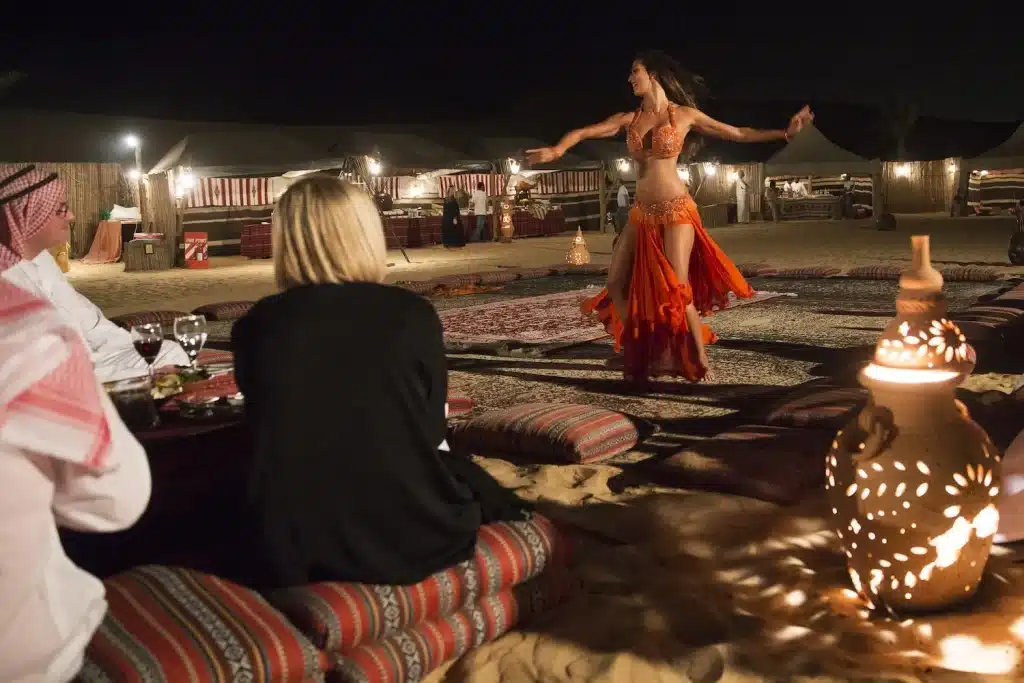 Guest watching Belly Dance in Desert safari Dubai Camp